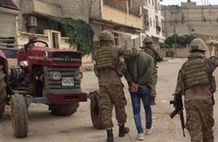 Islamic militias fail to arrest a young man, confronted with his mother's resistance